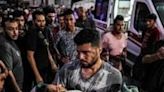 A man carries a girl who was injured by Israeli bombardment on al-Bureij outside the Aqsa Martyrs hospital in Deir el-Balah in the central Gaza Strip on June 4, 2024