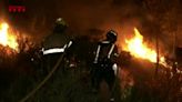 Firefighters battle wildfire approaching homes in Catalonia