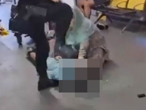 Moment armed policeman stamps on suspect's head during violent arrest