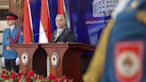 Hungary’s Prime Minister Viktor Orban receives a medal from pro-Russia Bosnian Serb president Dodik