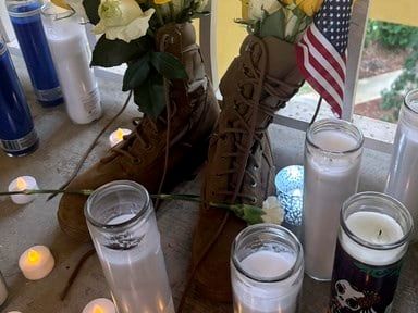 Questions and grief linger at the apartment door where a deputy killed a US airman