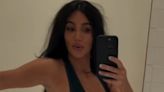 Kim Kardashian struggles to close bodysuit and enlists Khloe's help