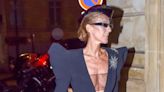 Celine Dion Is A High Fashion Flight Attendant In A Plunging Black Jumpsuit