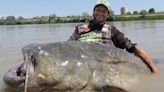 Fisherman lands world-record-size catfish that stretches over 9 feet