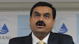 Hindenburg says Adani has been 'systematically looting' India as the conglomerate accuses the short-seller of `conflict of interest'