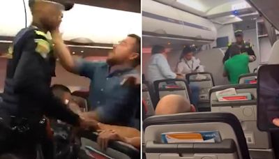 Moment airplane passengers launch racist attack on cop and SLAP him