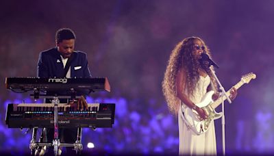 H.E.R. performs national anthem – and solos as Tom Cruise abseils into the stadium – at the Olympics closing ceremony