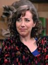 Kristen Schaal Wears Strawberry Colored Pants and a Multicolored Shirt