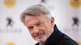'Jurassic Park' star Sam Neill tells fans to 'not worry too much' following cancer revelation and says that he is in remission: 'I'm alive and kicking'