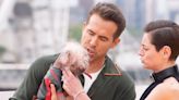 Ryan Reynolds pictured holding Dogpool at Deadpool and Wolverine photo call