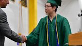 A graduate receives his diploma