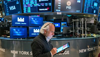 Dow closes at record high on tame inflation report, but TSX slips