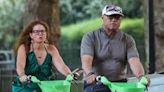 Laurence Fishburne rides an e-bike alongside mystery female companion