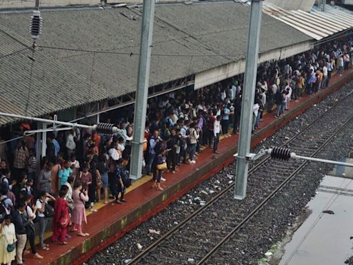 Mumbai news: Commuters walk on tracks as local train services disrupted by fallen bamboo structure | Watch video | Today News