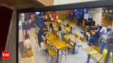 40 rounds of fire, chase, unfazed woman: CCTV shows chilling murder inside Burger King in Delhi | India News - Times of India