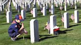 Vets' tombstones at Long Island National Cemetery planted with U.S. flags for Memorial Day