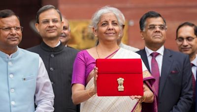 Budget 2024: FM Nirmala Sitharaman, Draped in White & Magenta Silk Saree, Poses With Tablet in Red Sleeve - News18