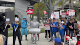 Dispatches From The Picket Lines, Day 24: Sen. Gillibrand & Colin Farrell Speak In NY; Lil Wayne Sends Burgers, A Robot...