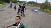 Children in remote Alaska aim for carnival prizes, show off their winnings and launch fireworks