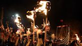 Pictured: Revellers wield axes and don Viking costumes for annual Up Helly Aa festival
