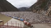 Huge floating island of rubbish fills picturesque Balkan river