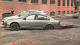 Car gets stuck in sinkhole in Pawtucket