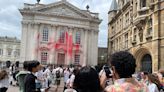 Pro-Palestine activists spray blood-red paint on Cambridge University graduation building