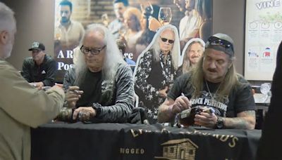 Lynyrd Skynyrd signs whiskey bottles for fans ahead of concert