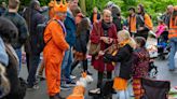 Orange crush: Boats packed with revelers tour Amsterdam canals to celebrate the king's birthday