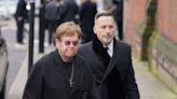 Sir Elton John and David Furnish attend funeral of Derek Draper
