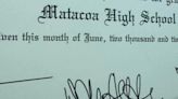 High school graduates receive diplomas with the school name misspelled