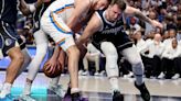 Luka Doncic of the Dallas Mavericks and Chet Holmgren of the Oklahoma City Thunder fight for the ball during the third quarter in Game 4 of the Western...