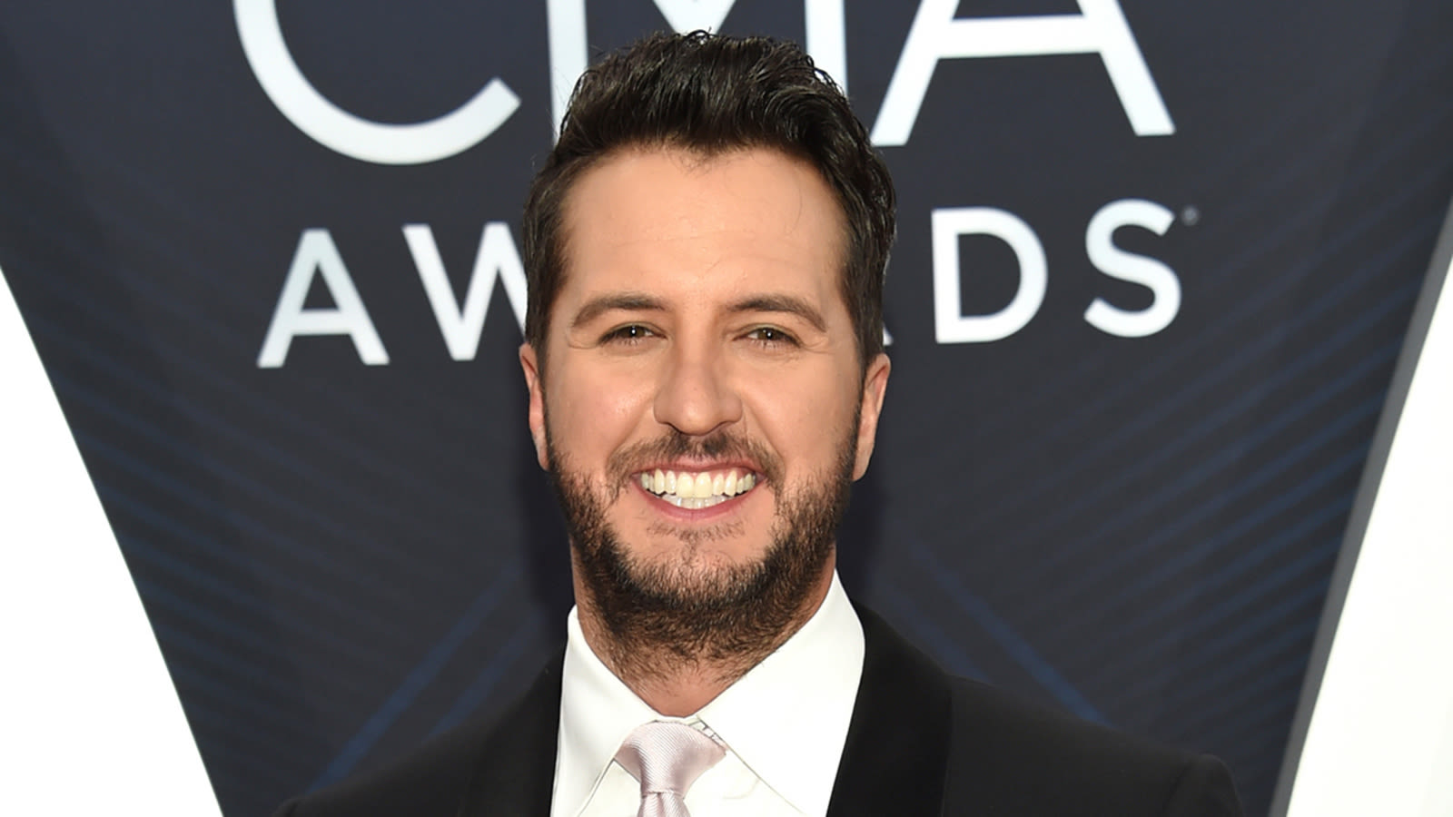 Luke Bryan brushes off onstage fall after slipping on fan's phone: 'My lawyer will be calling'