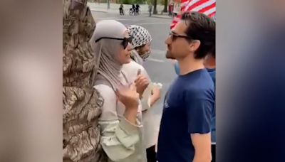 An Arizona State University research scholar is on leave after video shows him verbally attacking a woman in a hijab