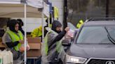 Parents brave the rain to secure three days of food for their children