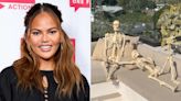 Chrissy Teigen Pokes Fun at Her Own Poolside Skeleton Display: ‘It’s Like “Love Island” in 100 Years’