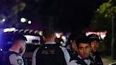 Police gather outside the Christ the Good Shepherd Church in Sydney's western suburb of Wakeley on Monday night