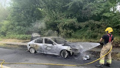 Torched car completely wrecked as firefighters put out flames
