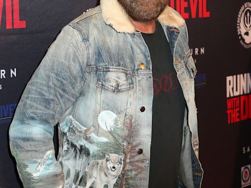 Nicolas Cage's bushy beard and cowboy hat are out in full force at movie premiere