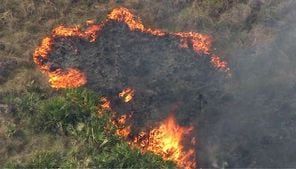 Firefighters battle brush fire that’s threatening structures in Lake County