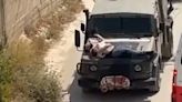 Video of Israeli soldiers driving with injured Palestinian strapped to a jeep sparks outrage