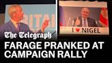 Watch: Farage speech interrupted by huge Putin banner