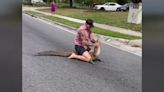 No shoes, no problem: Wild video shows Florida man using bare hands to remove 8-foot gator from busy road