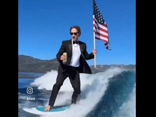 With US flag in hand, Mark Zuckerberg surfs in a suit while drinking beer