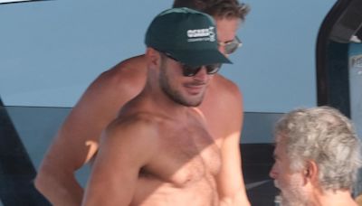 Zac Efron bares his chiseled chest as he goes shirtless on a yacht