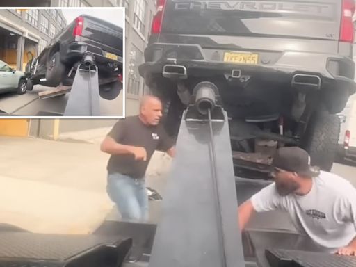 Wild video shows furious driver speed off in stolen tow truck — with his vehicle attached — while unleashing mayhem down street