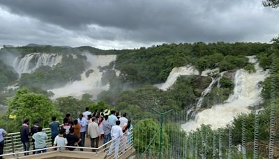 Tourists watch river Cauvery at Bharachukki falls in south Karnataka