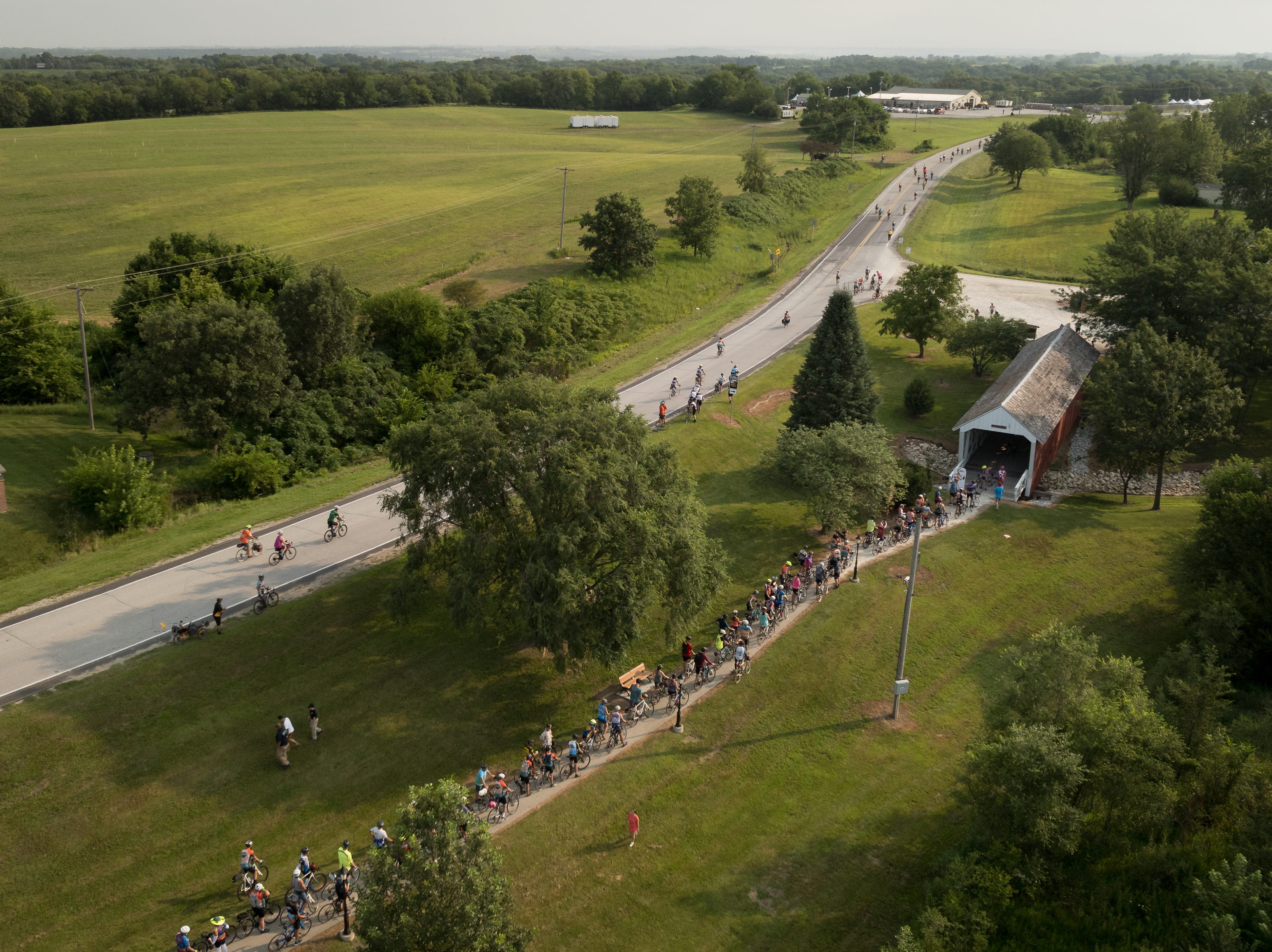 Riders line-up to bike through the Bridges of Madison County on RAGBRAI 2024