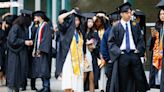 Boos, cheers and keffiyehs worn in silent protest at Emory commencement