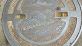 Answer Woman: Who makes the manhole covers with river, mountains and sky design? How many?